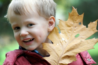 Little boy holding a leaf