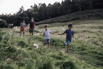 Family walk outdoors - Credit Evie and Tom Photography.