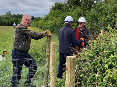 Volunteers installing new fencing