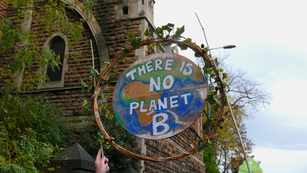Protest signed shaped like the globe with text reading: There is no planet B