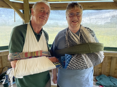 Two people with the arms supported by various materials